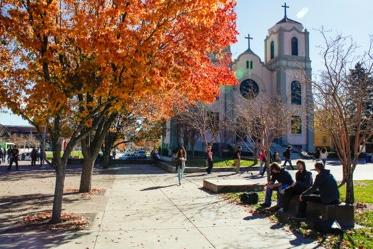 Students sitting outside St. Cajetan Church on campus