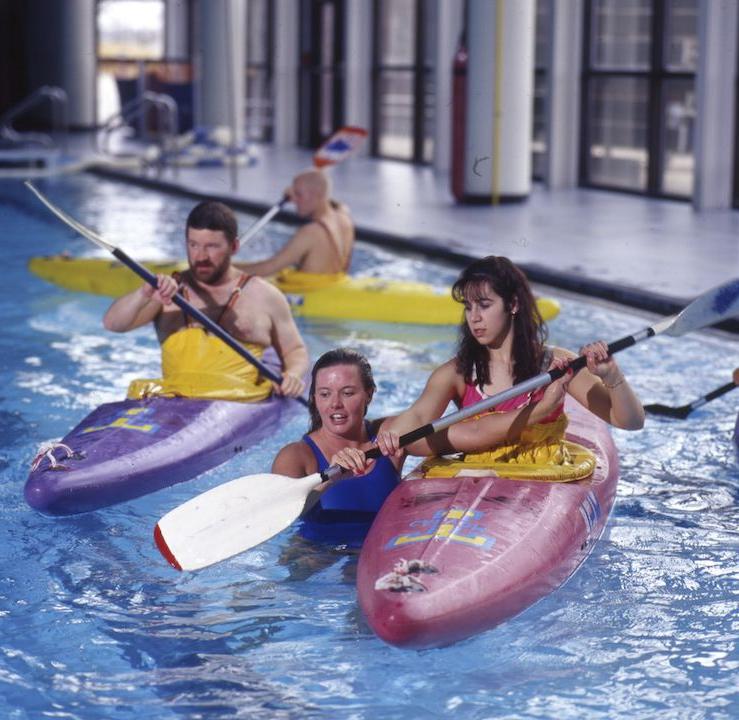 Students kayaking in the pool for a class