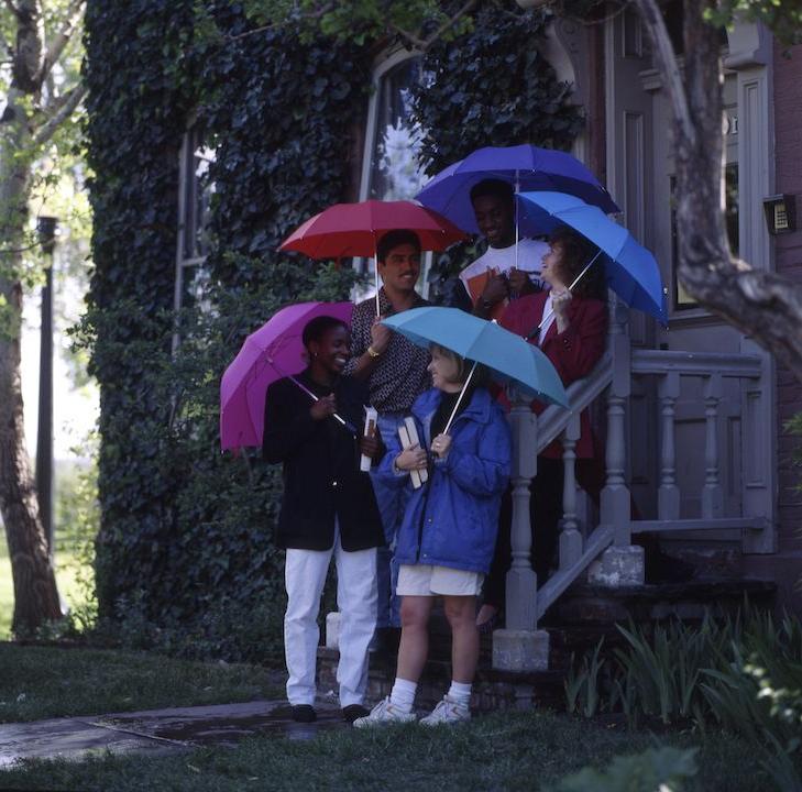 Roadrunners outside holding umbrellas