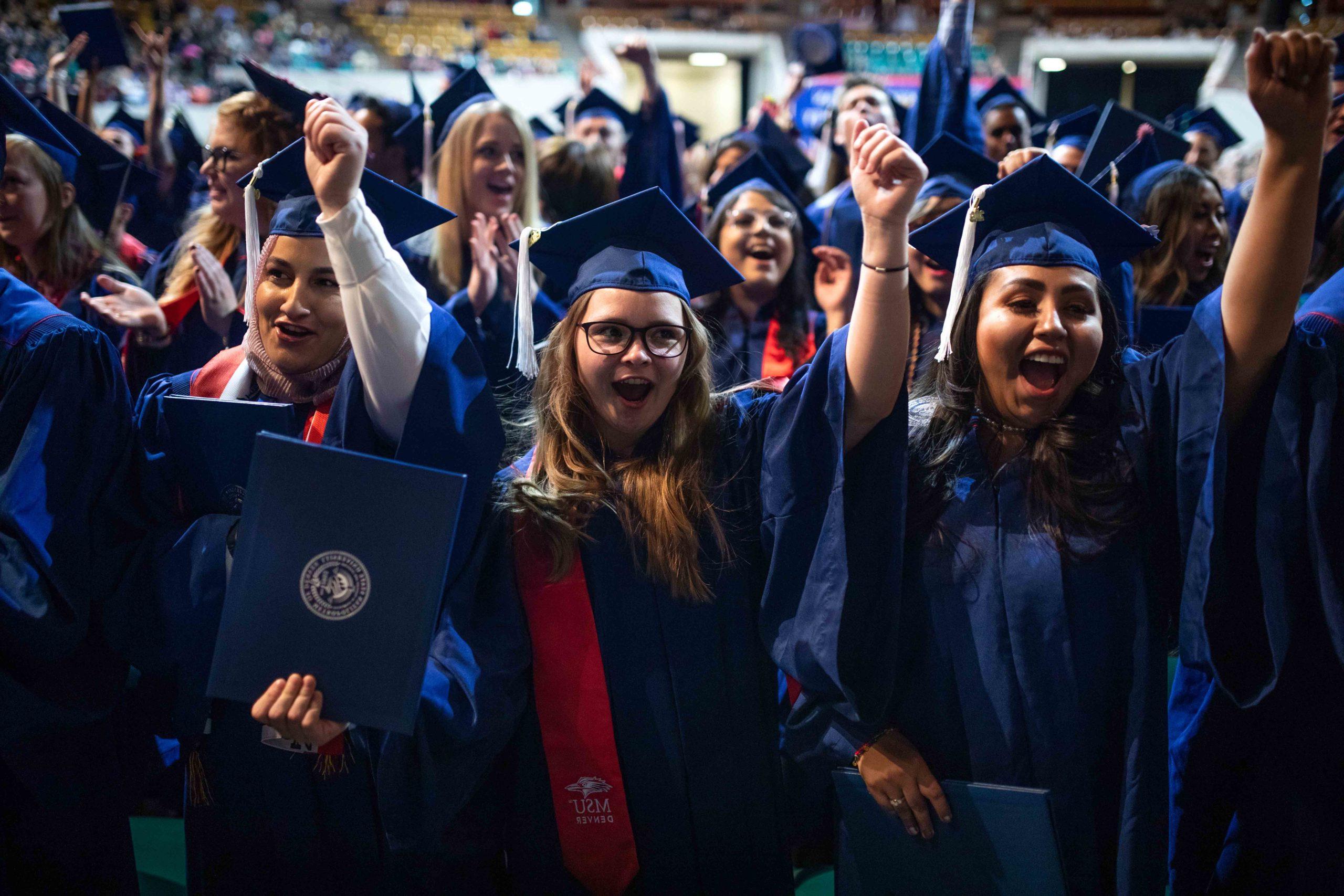 Graduates cheering during the commencement ceremony.