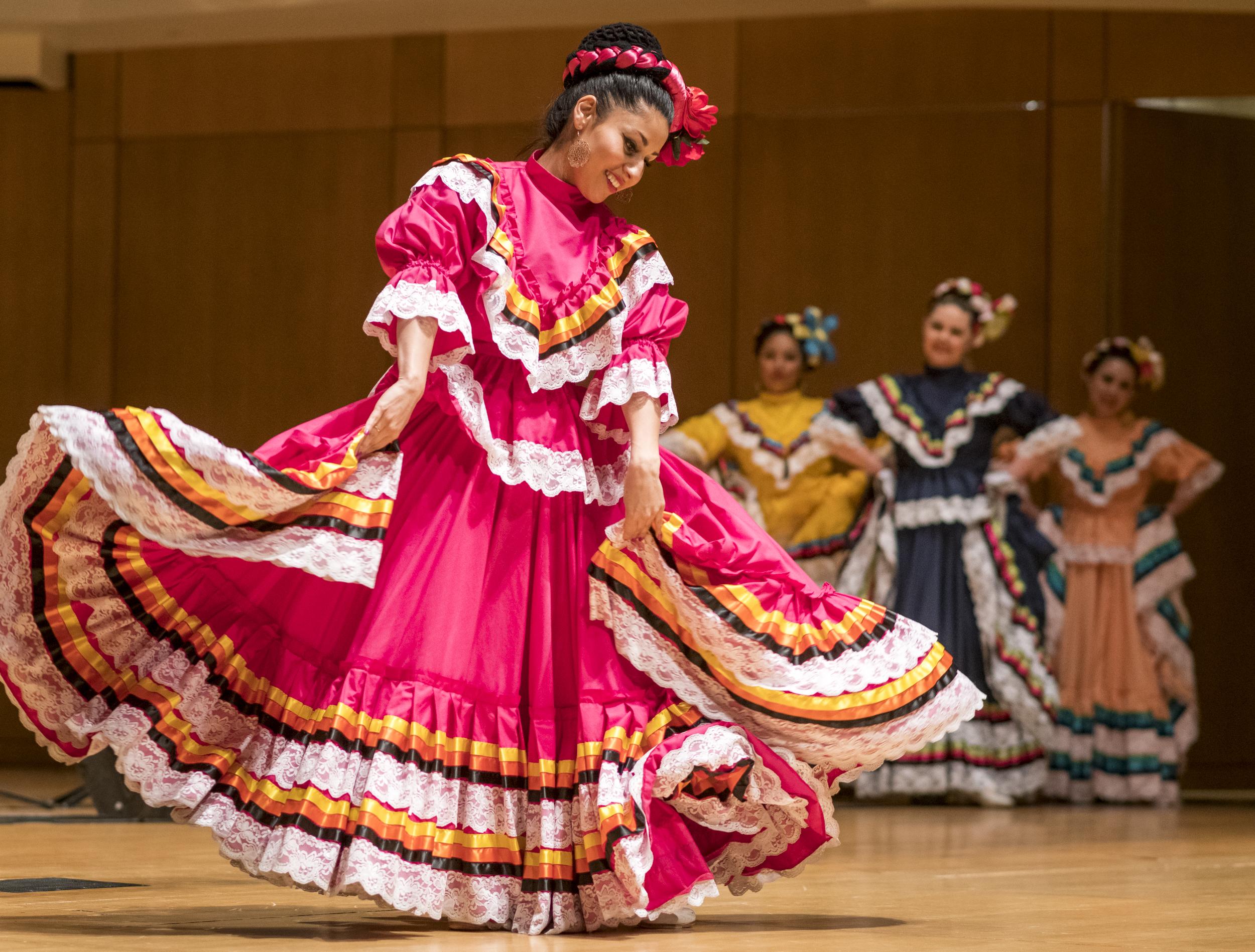 Folklorico dancer is traditional pink dress