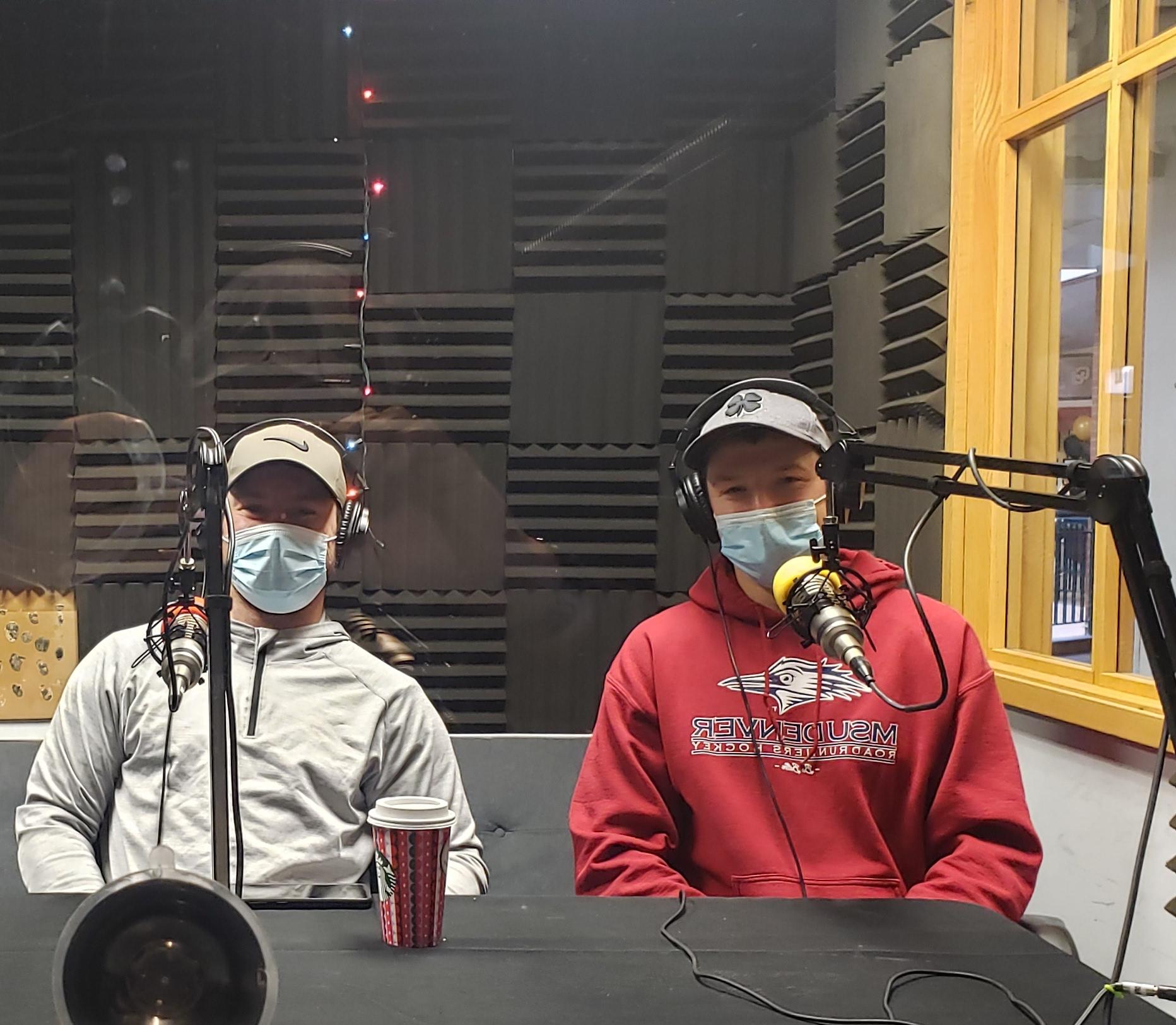 The President and Vice President of the 曲棍球俱乐部 team sitting in the podcast booth with headphones on