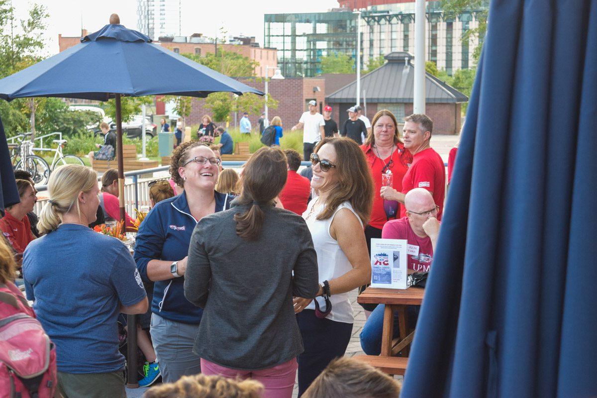 A group of people laughing at an event at the Tivoli Brewing Co. Tap House