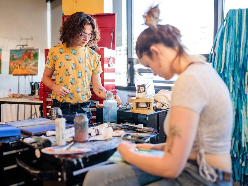 MSU Denver students, Joshua Capentor, right, and Sadie Hughes, works on a project in Painting and New Contexts class on May 3, 2023. Photo by Alyson McClaran